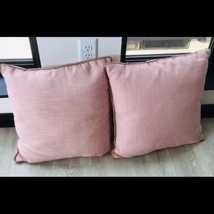Two light pink throw pillows